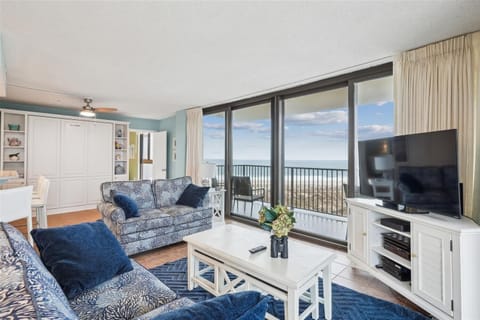 Sink into plush coastal-style sofas and gaze at your private ocean view through floor-to-ceiling windows—your perfect seaside escape awaits with style and comfort.