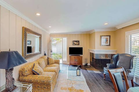 Settle into your sun-drenched Napa Valley living room with plush seating, a cozy fireplace, and flat-screen TV — your perfect home base between vineyard tours