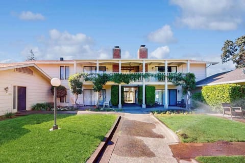 Welcome to your Napa Valley resort retreat — a charming two-story condo with ivy-draped balcony, manicured lawns, and classic lantern-lit walkways at Silverado Resort.