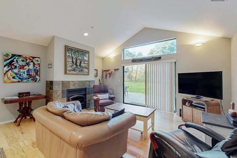 Unwind by the gas fireplace in your spacious living room with vaulted ceilings and sliding glass doors opening to the garden.