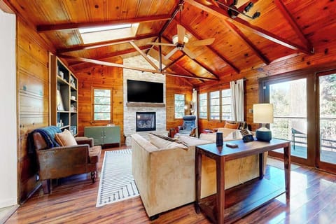 Settle into your warm, wood-paneled great room — vaulted knotty-pine ceilings, a stone fireplace, and flat-screen TV set the scene for wine country evenings along the Russian River.