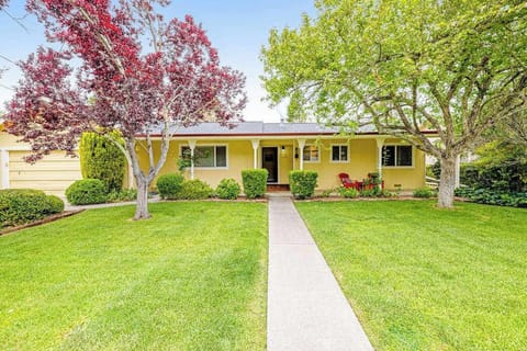 Welcome to your Kenwood wine country escape — a charming yellow ranch nestled among flowering trees and manicured gardens, steps from Sonoma Valley tasting rooms.