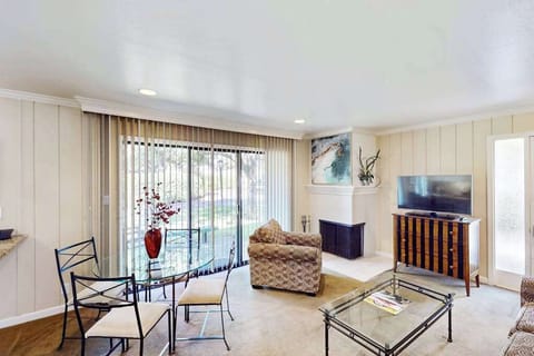 Gather around the glass dining table or lounge by the TV in your open-concept living space, with sliding doors framing views of Silverado's lush Napa Valley grounds.