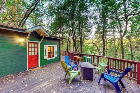 Gather around your private deck beneath the Russian River redwood canopy — colorful Adirondack chairs and a round table set the scene for wine country evenings under the stars.