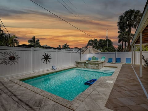 Private backyard pool at sunset with lounge seating—perfect for relaxing evenings and family time.