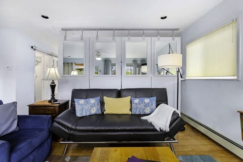 Living room Queen size futon, bedroom divider wall in the background
