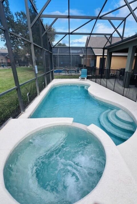 Private pool and spa with screened enclosure for relaxing family fun.