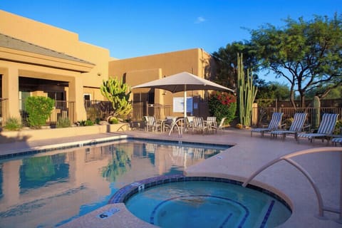 Relax by the community pool and spa, surrounded by desert landscaping, lounge seating, and a peaceful resort-style atmosphere. Located at neighborhood Community Center.