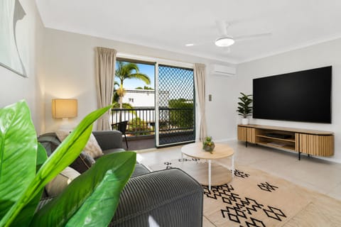 Stretch out on the plush lounge in the living room and settle in for a movie night on the impressive 75-inch TV, while natural light and coastal breezes create an inviting setting between beach adventures.