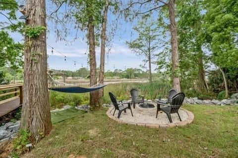 Private waterfront backyard in Perdido Key with fire pit, dock, and direct water access to the bay—ideal for boating, relaxing, and enjoying the natural coastal surroundings.