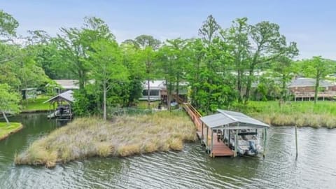 Aerial view of the private dock extending into the canal, surrounded by lush Florida greenery.