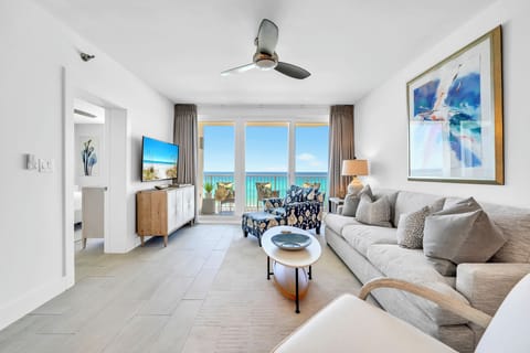 Sink into this plush sectional sofa while ocean breezes flow through your balcony doors, creating the perfect coastal retreat.