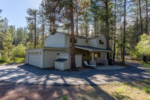 An expansive driveway welcomes you in, leading to a covered outdoor seating area perfect for relaxing, along with a gas grill and private hot tub for the ultimate Sunriver experience.