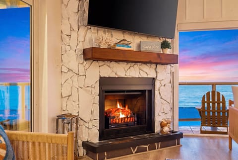 70-inch Roku TV above the fireplace — watch the TV and the Gulf at once.