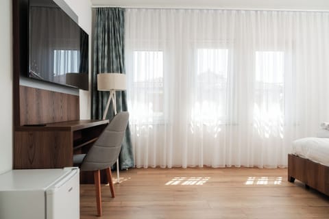Deluxe Triple Room, City View | Desk, laptop workspace, free WiFi