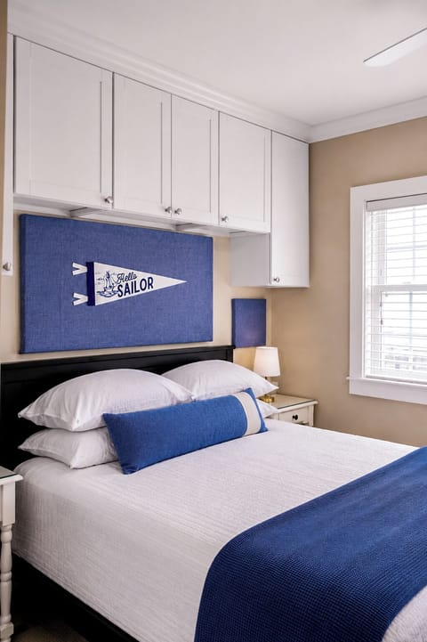 Coastal-inspired bedroom with built-in storage and crisp blue accents
