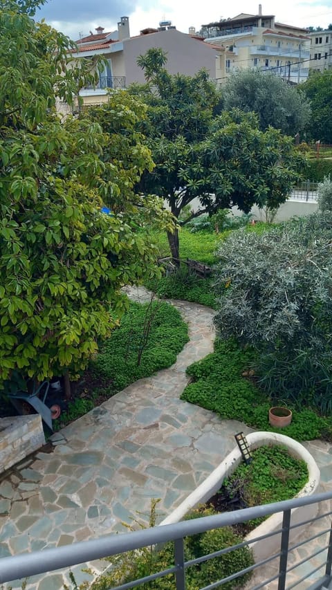 A view over the shared garden area, with trees and greenery creating a calm setting around the building. You step outside and immediately feel removed from the pace of the city, with space to slow down.