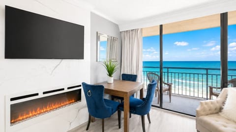 Wake up to sweeping Atlantic views at this bright oceanfront retreat at Coral Beach Resort, with a fireplace and dining nook nearby.