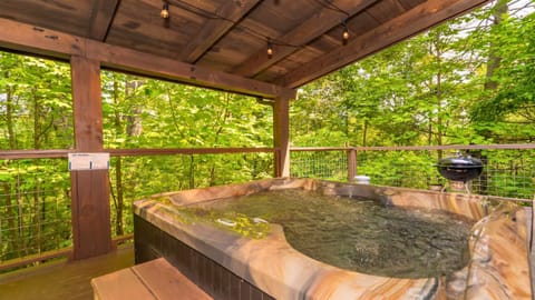 Soak your cares away in the private hot tub while taking in peaceful mountain views.
