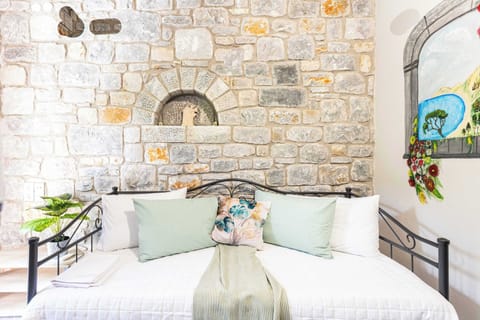 Cozy lounge area featuring authentic stone walls and traditional Mani character
