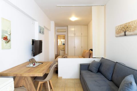 Bright living area with sofa, TV, and dining space