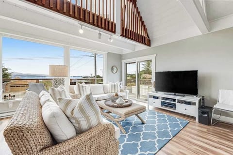 Kick back on the wicker sofa and take in sweeping harbor views through floor-to-ceiling windows — your flatscreen TV is there when the sunsets finally fade.