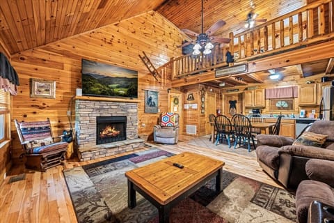 With comfortable seating, a warm fireplace, and the kitchen just steps away, this open living space is made for spending quality time together.