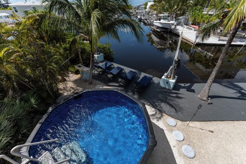 Pool area overlooking the canal with lounge chairs nearby for relaxing