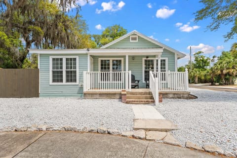 The front elevation of this beach bungalow features a wide, welcoming porch that stretches across the home, creating a classic coastal first impression.