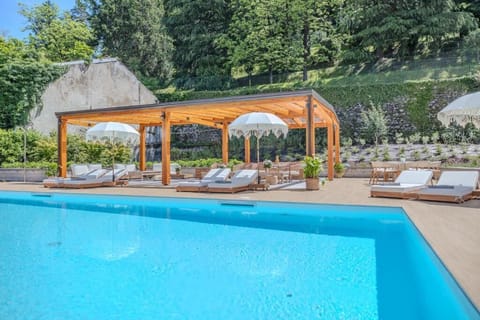 Seasonal outdoor pool, open 11:00 AM to 8:00 PM, pool umbrellas
