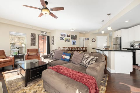 Settle into Base Camp 305 your spacious open-concept living room, where cozy seating flows into a fully equipped kitchen perfect for gathering.