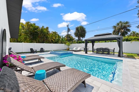 Private Salt Water pool & spa with sun loungers—your perfect backyard oasis for relaxing and soaking up the Naples sunshine.