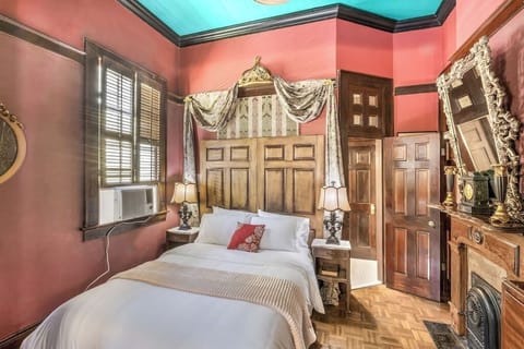 Elegant bedroom with rich colors, vintage furnishings, and ornate details for a truly unique stay.