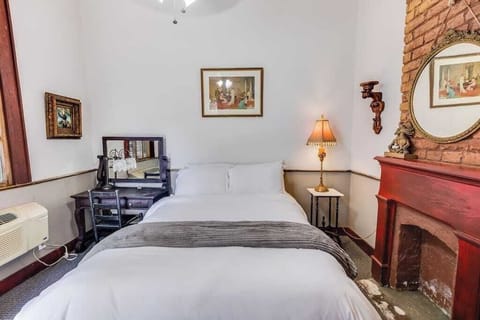 Cozy bedroom with classic furnishings, warm lighting, and a comfortable, homey feel.