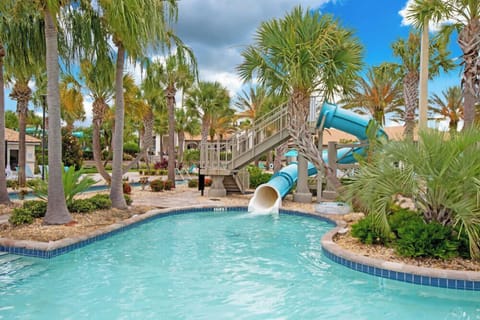 Enjoy the family-friendly pool area with a winding water slide surrounded by tropical landscaping.