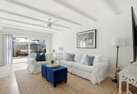 Bright and inviting living space with wood-beamed ceilings and a relaxed coastal feel