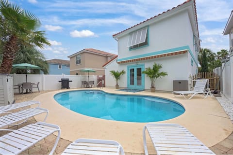 Private Backyard Pool

A sun-drenched backyard oasis featuring a sparkling curved swimming pool surrounded by white lounge chairs. Teal accents on the house trim and vibrant potted palms create a refreshing, tropical resort vibe.