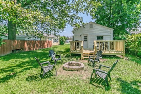 Spacious, private fenced-in backyard featuring a brand-new wooden deck with outdoor dining. Relax by the stone fire pit with provided Adirondack chairs, perfect for evening s'mores.