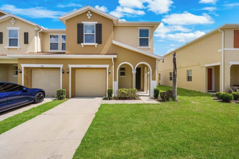 Welcome to 5129 Compass Bay-a sunny townhome with Mediterranean flair, private driveway/garage, and a charming arched entry.