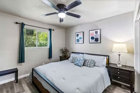 Rest easy in this inviting primary bedroom, featuring a king bed designed for comfort and simplicity.