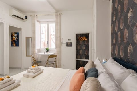 Elegant and airy bedroom with designer décor, natural light, and a cozy boutique