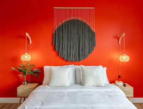 White bedding provides a clean contrast against the bold red background.