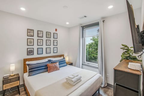 Charming Bedroom Retreat, relax in stylish comfort with artful decor and a serene view.