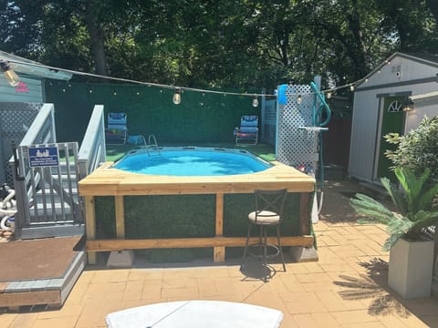 Private backyard plunge pool with lounge seating and cozy string lights