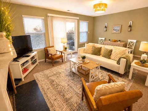 Bright and cozy living room with warm lighting, stylish décor, and comfortable seating filled with natural light.