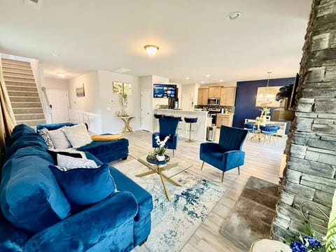 Spacious living room with blue sofas and modern open layout.