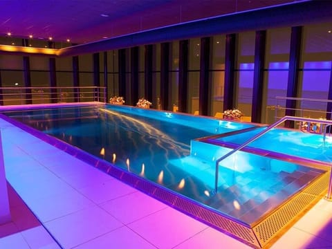 Swim under evening glow for a resort-like escape.