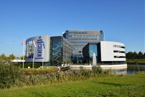 Arrive to a modern waterfront hotel with striking architecture.