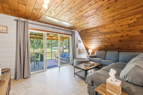 Living room with sliding deck access, pond views, and seating for the whole group.