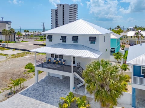 Elevated coastal living in Fort Myers Beach. Features expansive outdoor seating, ample covered parking, and prime beach access just down the street.